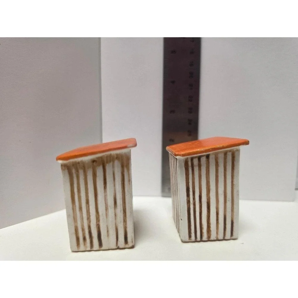 vintage, comical salt and pepper shakers feature an outhouse design with humorou